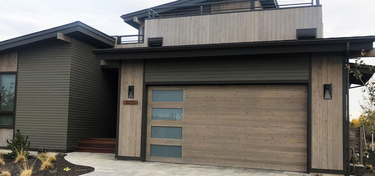 Custom wood garage door with vertical windows 