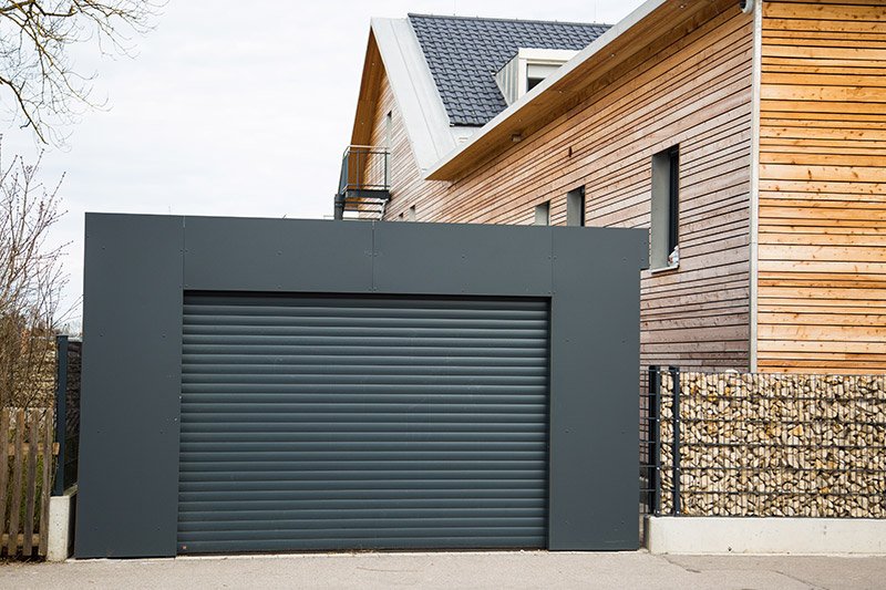 beautiful house with a black steel garage door